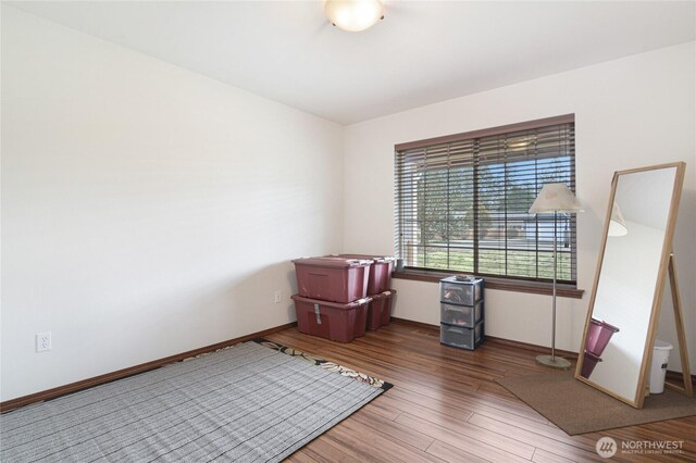 empty room with wood finished floors and baseboards