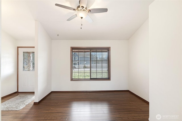 unfurnished room with a ceiling fan, baseboards, and wood finished floors