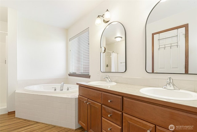 full bath with double vanity, a garden tub, a sink, and a shower with shower curtain