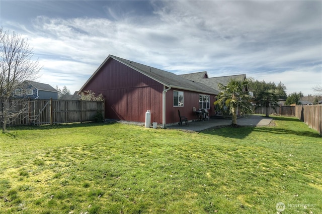 exterior space with a patio area, a fenced backyard, and a yard