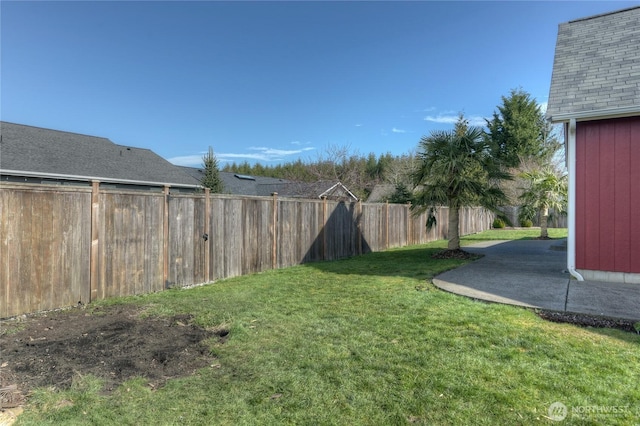 view of yard featuring a patio area and a fenced backyard