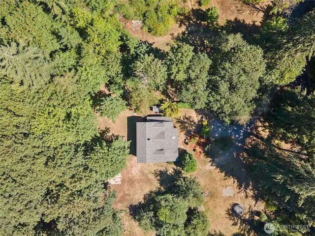 birds eye view of property featuring a view of trees