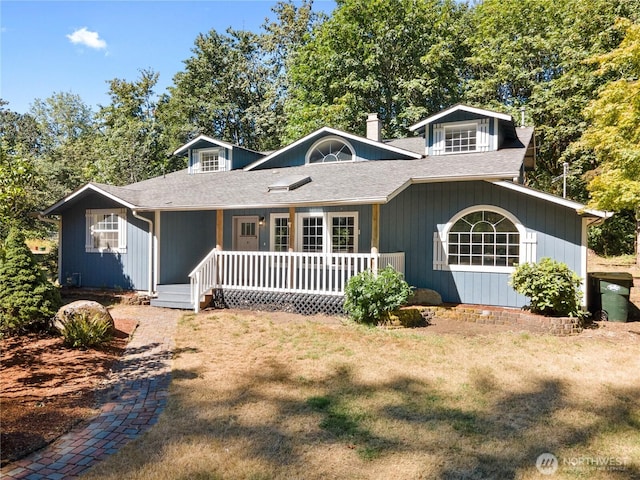 ranch-style home with a porch, a front lawn, and a shingled roof