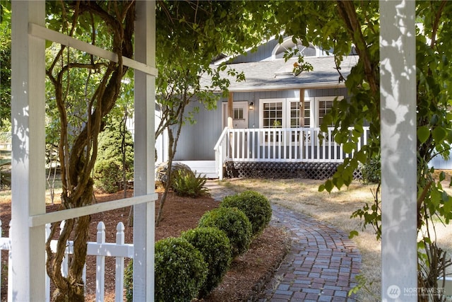 exterior space with covered porch and fence