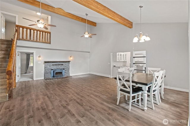 dining space featuring baseboards, wood finished floors, and stairs