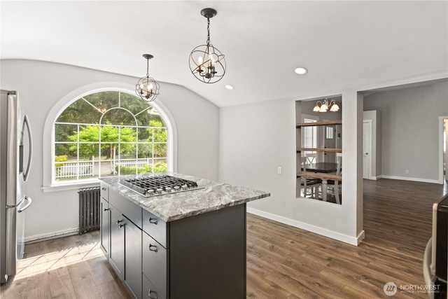 kitchen featuring dark wood finished floors, radiator heating unit, a center island, recessed lighting, and appliances with stainless steel finishes