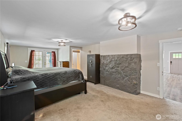 bedroom with carpet, multiple windows, french doors, and baseboards