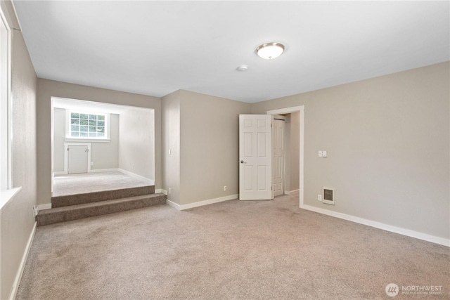 unfurnished bedroom featuring visible vents, carpet floors, and baseboards