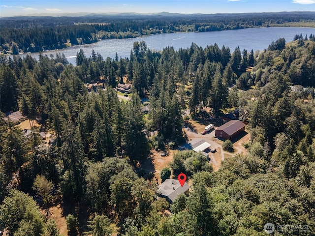 aerial view with a forest view and a water view