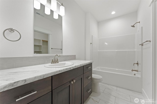 bathroom featuring visible vents, bathing tub / shower combination, toilet, marble finish floor, and vanity