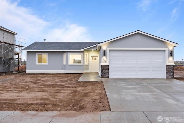 ranch-style home featuring roof with shingles, stucco siding, concrete driveway, an attached garage, and stone siding