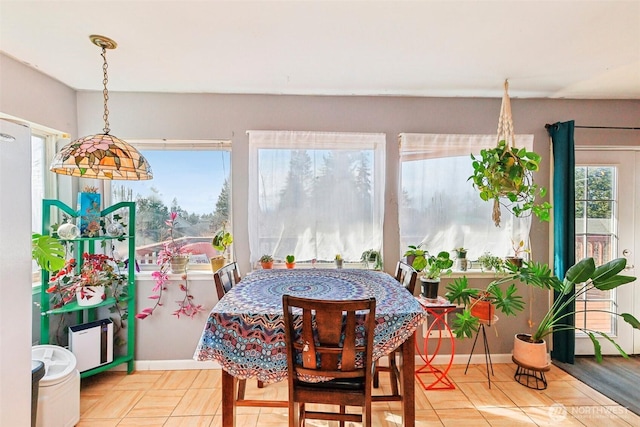 dining area with light tile patterned floors and baseboards