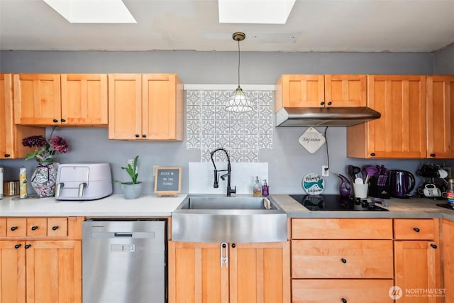 kitchen with a skylight, a sink, under cabinet range hood, stainless steel dishwasher, and black electric stovetop