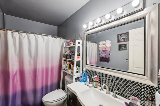 full bathroom featuring vanity, toilet, and tasteful backsplash