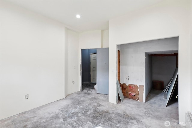 unfurnished bedroom featuring concrete floors