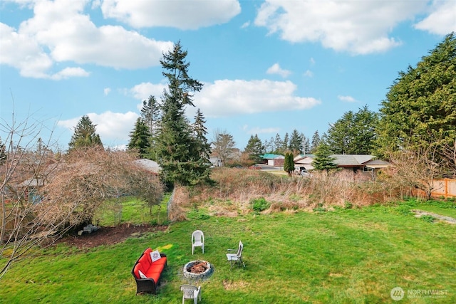 view of yard featuring an outdoor fire pit