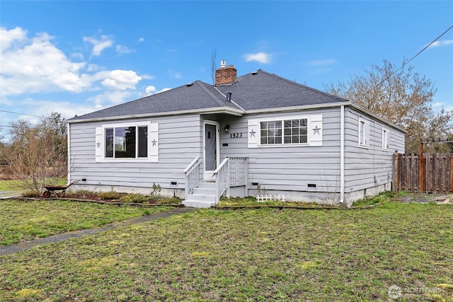 view of front of home with a chimney, a shingled roof, a front yard, crawl space, and fence