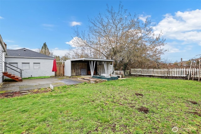 view of yard with a patio, an outdoor structure, and fence