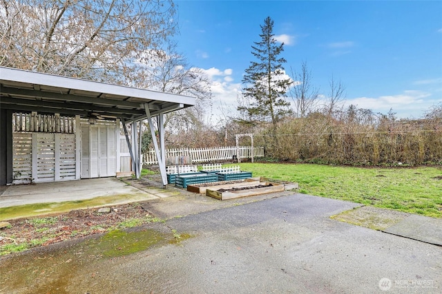 exterior space featuring fence and a garden