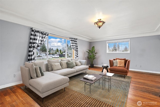 living room with a healthy amount of sunlight, baseboards, and wood finished floors