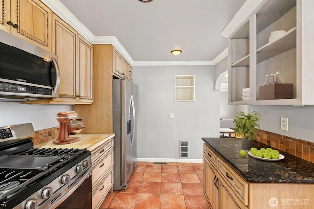 kitchen featuring ornamental molding, stainless steel appliances, tasteful backsplash, and visible vents