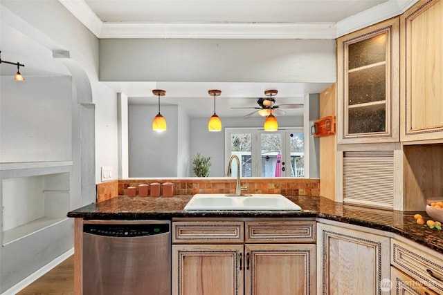 kitchen featuring a peninsula, a sink, dishwasher, dark stone countertops, and glass insert cabinets