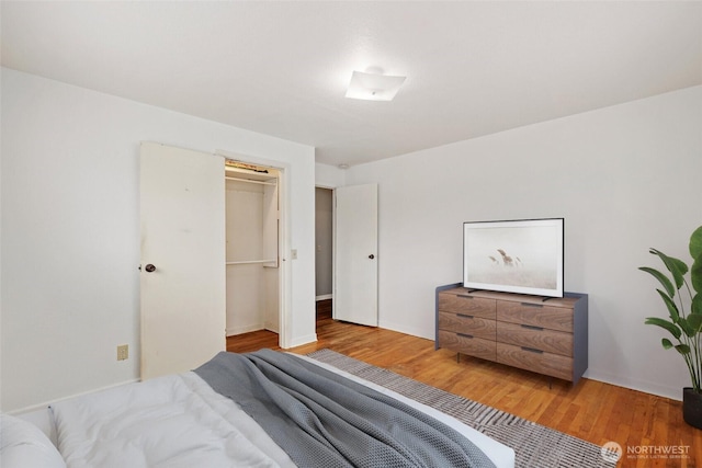 bedroom with a closet and wood finished floors