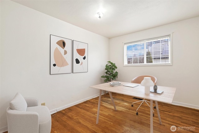 office area featuring baseboards and wood finished floors