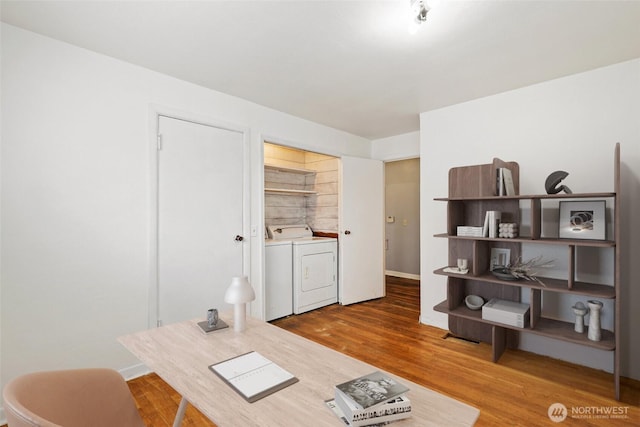 office featuring baseboards, washer and dryer, and wood finished floors