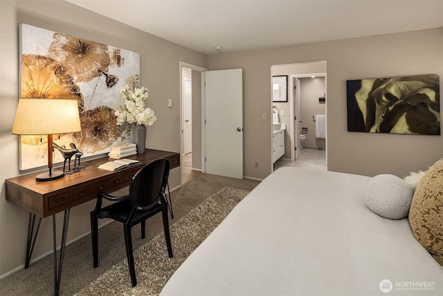 bedroom with carpet, baseboards, and ensuite bathroom