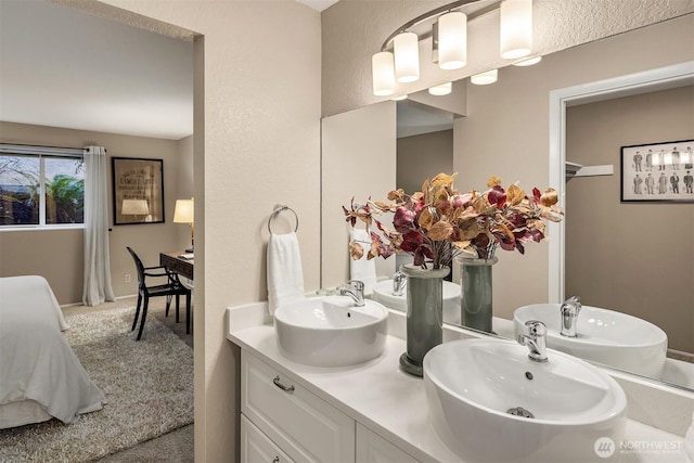 ensuite bathroom featuring a sink, ensuite bathroom, and double vanity