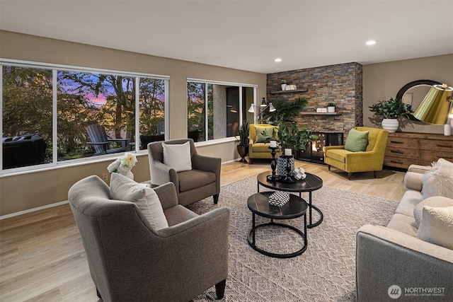 living room with a fireplace, baseboards, wood finished floors, and recessed lighting