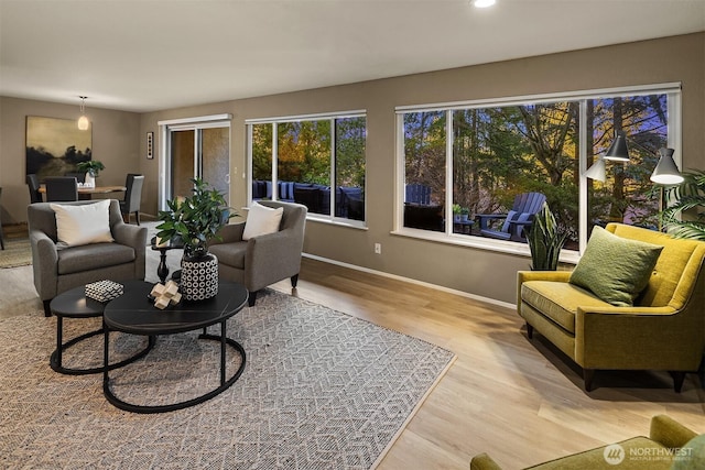 living room featuring light wood finished floors and baseboards