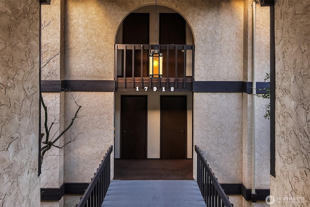 property entrance with stucco siding