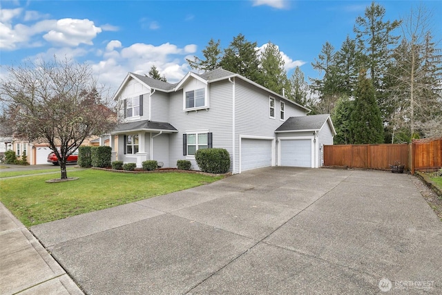 traditional home with an attached garage, concrete driveway, a front yard, and fence