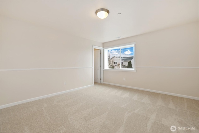 spare room featuring visible vents, baseboards, and light colored carpet