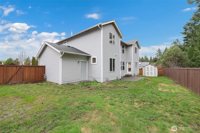 back of house with an outbuilding, a patio, a shed, a fenced backyard, and a lawn