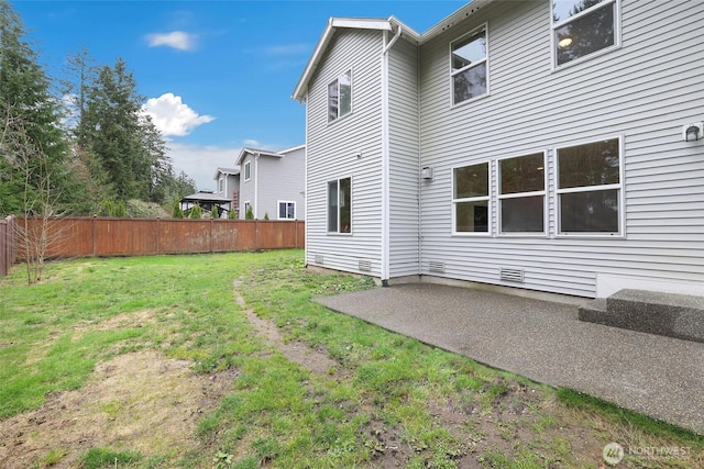 back of property with a patio area, a lawn, fence, and crawl space