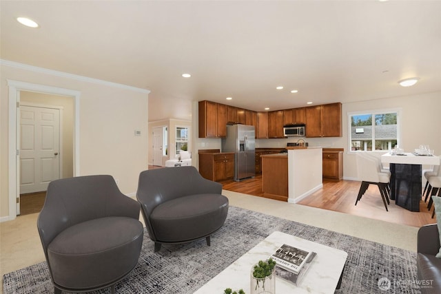 living area featuring recessed lighting, baseboards, crown molding, and light wood-style floors