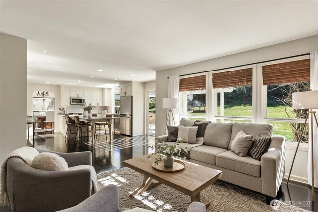 living room with recessed lighting, plenty of natural light, and dark wood-type flooring