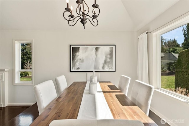 dining space featuring lofted ceiling, a notable chandelier, and a healthy amount of sunlight