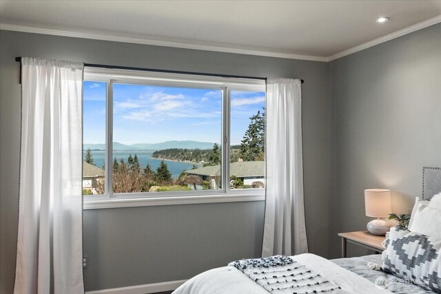 bedroom with recessed lighting, crown molding, and a water view