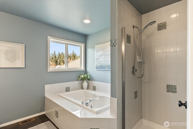 full bathroom featuring a tile shower, visible vents, and a garden tub