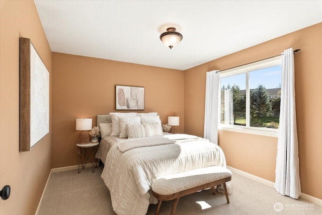 bedroom with light carpet and baseboards