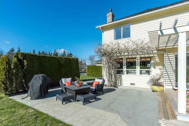 view of patio with area for grilling and a pergola