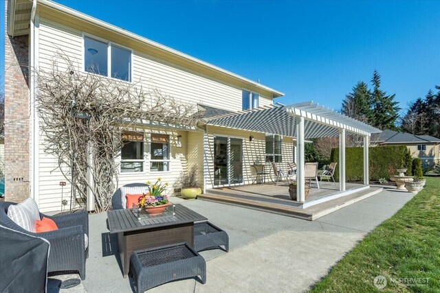 rear view of property with a patio and a pergola