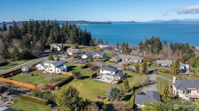 birds eye view of property with a water view and a residential view