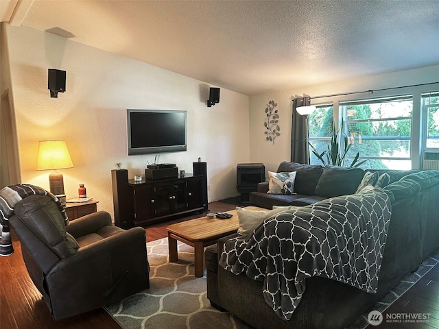 living room featuring lofted ceiling, a textured ceiling, and wood finished floors