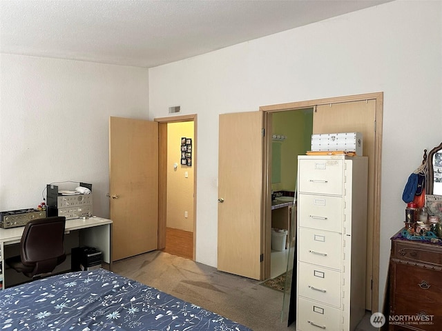 carpeted bedroom featuring lofted ceiling and visible vents