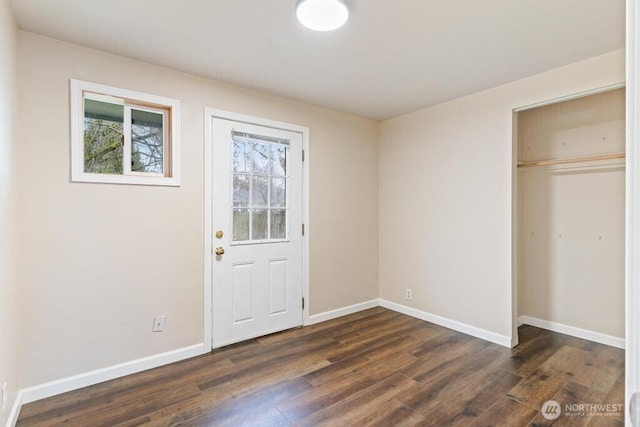 interior space with baseboards and dark wood-style floors